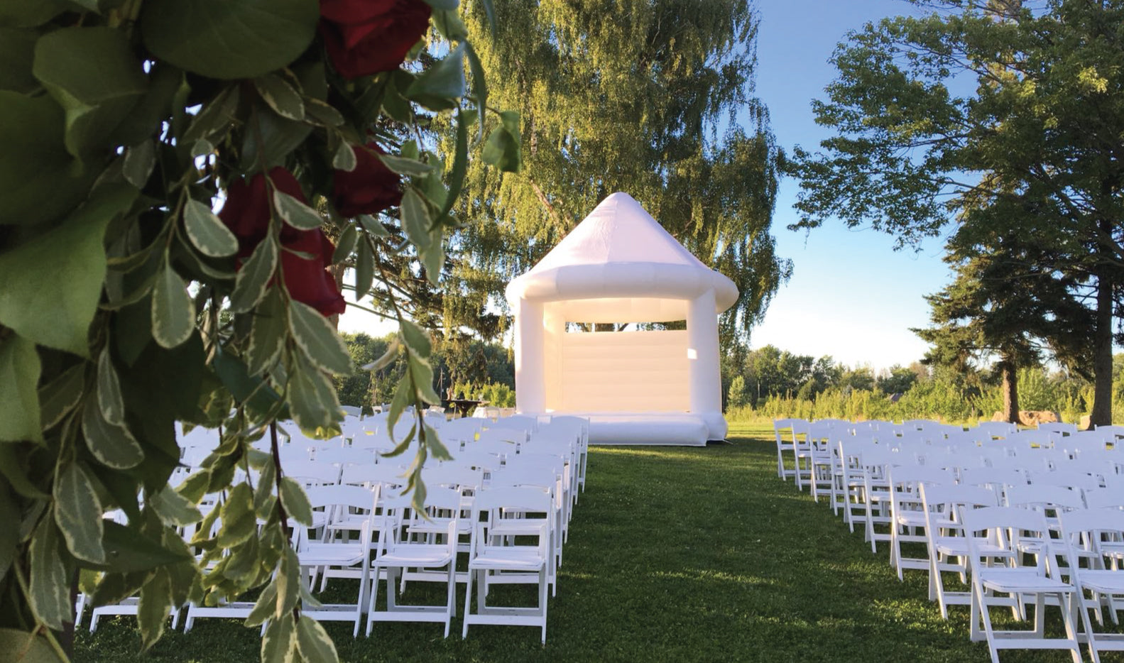 white wedding bouncer at a ceremony with rose